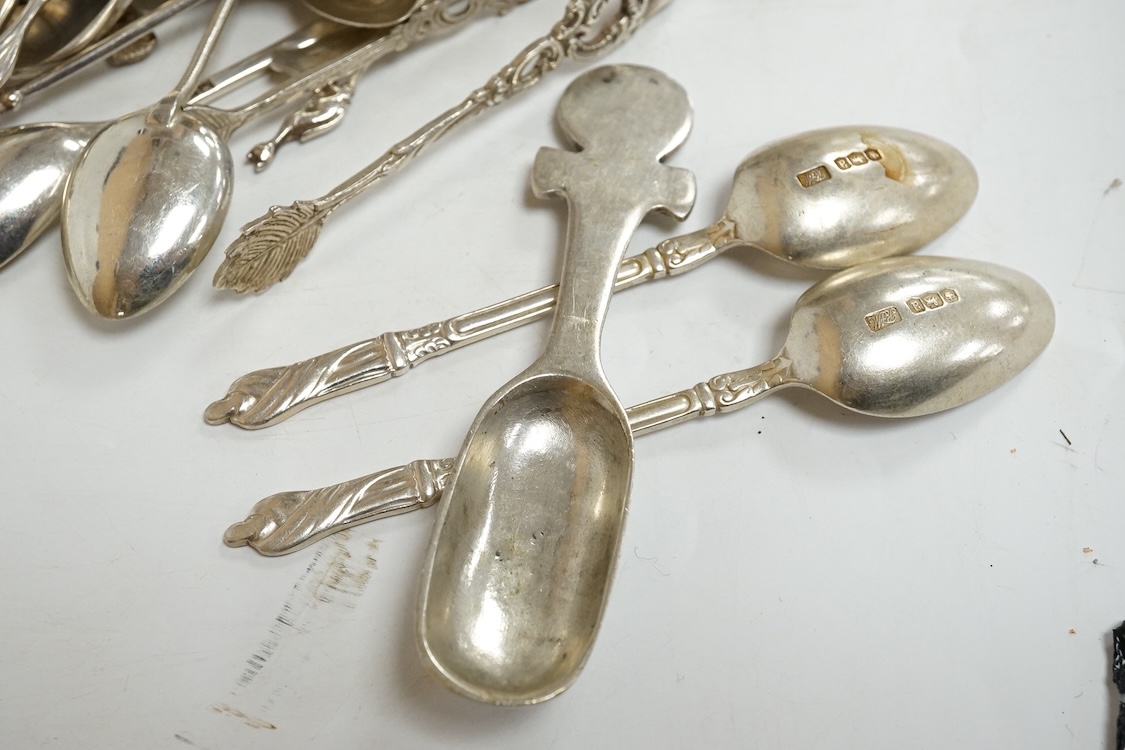 A group of assorted silver and white metal tea and coffee spoons and a pair of silver sugar tongs, weighable hallmarked silver 8.6oz.